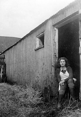 Nancy Lusher at the cow stalls - January 1943